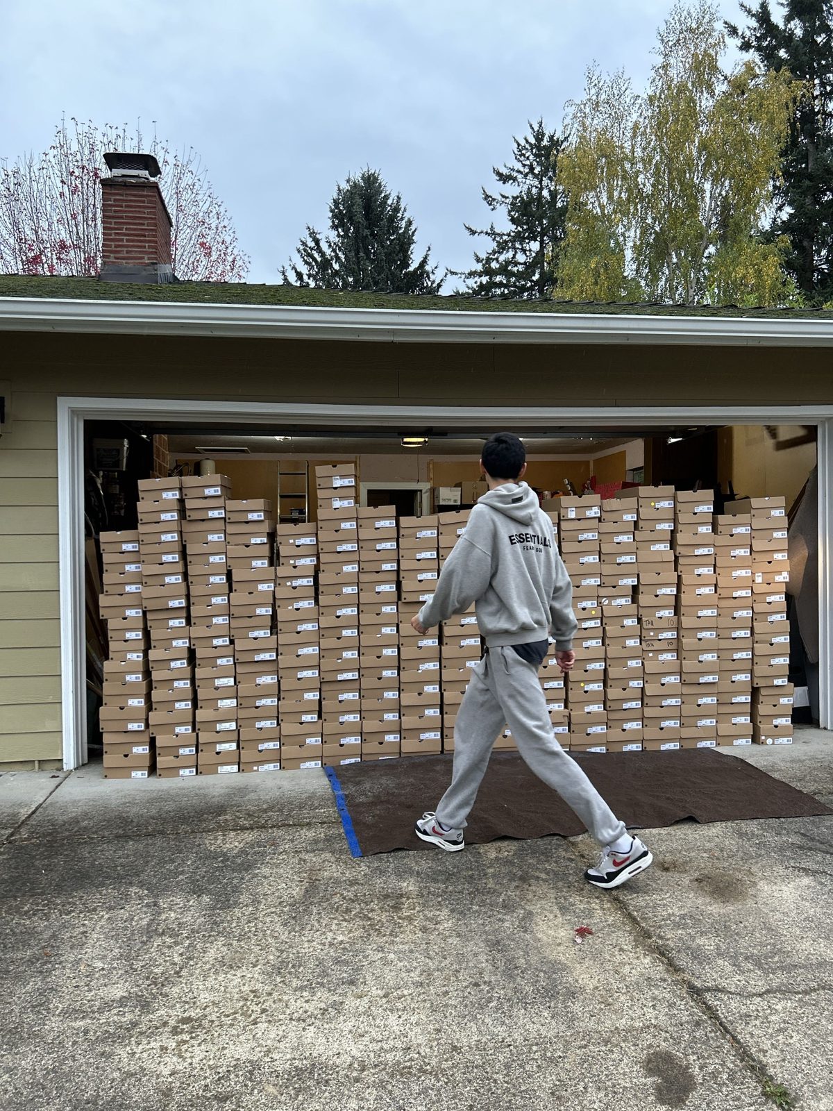 Ben walking past a garage stacked floor to ceiling with shoe boxes from a single lead